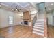 Spacious living room featuring a brick fireplace, built-in shelves, coffered ceilings, and elegant hardwood flooring at 721 Wedowee St, Bowdon, GA 30108