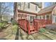 Charming red deck perfect for outdoor dining and entertaining with brick accents and stone patio at 300 The Enclave, Peachtree City, GA 30269