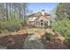 View of the backyard showcasing a deck, brick facade, and a lush landscape at 300 The Enclave, Peachtree City, GA 30269