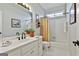Bright bathroom with a large mirror, a white vanity, and a combination tub and shower at 300 The Enclave, Peachtree City, GA 30269