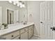 Clean bathroom features a sink with a large mirror, bright lighting, and white fixtures for a simple, elegant space at 300 The Enclave, Peachtree City, GA 30269