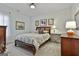 Tastefully decorated bedroom with floral bedding and coordinated decor creates a cozy and inviting atmosphere in this home at 300 The Enclave, Peachtree City, GA 30269