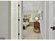 Bedroom featuring a floral bedspread and antique dressers seen from the doorway offers a glimpse into a serene and inviting interior at 300 The Enclave, Peachtree City, GA 30269