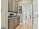 Butler pantry featuring granite countertops and cabinets with convenient access to other areas at 300 The Enclave, Peachtree City, GA 30269