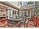 Deck with a dining table offers outdoor dining with multiple windows for inside/outside enjoyment at 300 The Enclave, Peachtree City, GA 30269