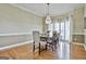 Elegant dining room with hardwood floors, chandelier, and large windows offering natural light at 300 The Enclave, Peachtree City, GA 30269