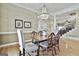 Open-concept dining room featuring chandelier, hardwood floors, and easy access to the staircase at 300 The Enclave, Peachtree City, GA 30269