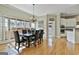 Bright dining room featuring a wood table, leather chairs, and large windows letting in natural light at 300 The Enclave, Peachtree City, GA 30269