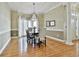 Elegant dining room with hardwood floors, chandelier, and large windows offering natural light at 300 The Enclave, Peachtree City, GA 30269