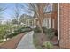 Brick home with a covered front porch and a landscaped walkway at 300 The Enclave, Peachtree City, GA 30269