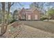 Traditional brick home with a covered porch and a nicely sloped front yard at 300 The Enclave, Peachtree City, GA 30269