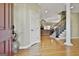 Elegant foyer with hardwood floors, staircase, and view into the living room at 300 The Enclave, Peachtree City, GA 30269