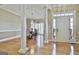 Open-concept foyer features hardwood floors and access to the dining area at 300 The Enclave, Peachtree City, GA 30269