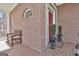 Charming front porch with brick accents, seating, and decorative potted plants at 300 The Enclave, Peachtree City, GA 30269