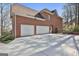 Spacious three-car garage and extended driveway enhance this property's functionality at 300 The Enclave, Peachtree City, GA 30269