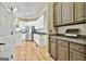 Featuring white cabinets and stainless steel appliances with a view into the connected butler's pantry at 300 The Enclave, Peachtree City, GA 30269