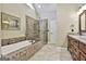 Luxurious main bathroom with a soaking tub and glass shower at 300 The Enclave, Peachtree City, GA 30269