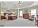 Spacious main bedroom with a tray ceiling, carpet, and lots of natural light at 300 The Enclave, Peachtree City, GA 30269
