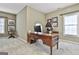 Spacious office featuring a large wood desk, leather chair, and bright windows for a functional workspace at 300 The Enclave, Peachtree City, GA 30269