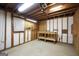 Unfinished basement with exposed wood beams, a small window and a workbench at 40 Derby Country Dr, Ellenwood, GA 30294