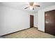 Spacious bedroom features neutral carpeting, a ceiling fan, and a doorway at 40 Derby Country Dr, Ellenwood, GA 30294