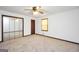 Carpeted bedroom features mirrored closet doors, ceiling fan, and a window at 40 Derby Country Dr, Ellenwood, GA 30294