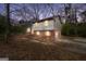 Two-story home featuring a brick and vinyl exterior, nestled in a wooded landscape with an attached garage at 40 Derby Country Dr, Ellenwood, GA 30294