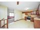 Traditional kitchen features classic cabinetry, white appliances, and durable tile flooring at 40 Derby Country Dr, Ellenwood, GA 30294