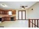 Vintage kitchen with wood cabinets, vintage-patterned wallpaper, and a door providing access to outdoor space at 40 Derby Country Dr, Ellenwood, GA 30294