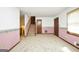 Living room featuring neutral carpet, two-tone walls, staircase, and doorways leading to other rooms in the home at 40 Derby Country Dr, Ellenwood, GA 30294