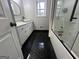 Updated bathroom featuring a black hexagon tile floor, and modern fixtures and finishes at 127 Brookwood Estates Trl, Stockbridge, GA 30281