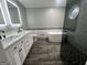 Modern bathroom featuring a double sink vanity, a standalone tub, and a glass-enclosed shower at 127 Brookwood Estates Trl, Stockbridge, GA 30281