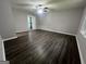 Inviting bedroom featuring dark wood flooring, soft gray walls, and a ceiling fan with lighting at 127 Brookwood Estates Trl, Stockbridge, GA 30281