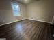 Neutral bedroom with luxury vinyl plank flooring and a window that brings in natural light at 127 Brookwood Estates Trl, Stockbridge, GA 30281