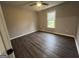 Cozy bedroom with luxury vinyl plank flooring, neutral color palette, and a bright window at 127 Brookwood Estates Trl, Stockbridge, GA 30281