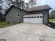 Spacious garage with a white door and large driveway providing ample parking space at 127 Brookwood Estates Trl, Stockbridge, GA 30281