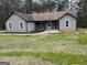 Charming one story home with a covered porch, gray siding, and a well-manicured lawn at 127 Brookwood Estates Trl, Stockbridge, GA 30281