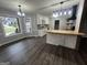 Bright kitchen with white cabinets, wooden countertops, and modern lighting fixtures at 127 Brookwood Estates Trl, Stockbridge, GA 30281