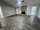 Spacious living room with modern gray walls, wood flooring, and a stone fireplace at 127 Brookwood Estates Trl, Stockbridge, GA 30281