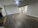 Bright living room showcasing gray walls, dark wood flooring, and open access to other rooms at 127 Brookwood Estates Trl, Stockbridge, GA 30281