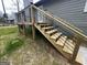 Newly built wooden stairs lead to a deck with modern black metal railing at 127 Brookwood Estates Trl, Stockbridge, GA 30281