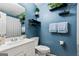 Cozy bathroom with blue walls, decorative shelves, and white fixtures at 152 Summerfield Dr, Mcdonough, GA 30253