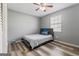 Comfortable bedroom with modern ceiling fan, wood floors, and natural light at 152 Summerfield Dr, Mcdonough, GA 30253