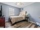 Comfortable bedroom with hardwood floors, a ceiling fan, and a cozy beige headboard at 152 Summerfield Dr, Mcdonough, GA 30253