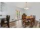 Bright dining room with a wooden table set, chandelier, and access to the deck at 152 Summerfield Dr, Mcdonough, GA 30253