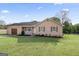 Tan home exterior featuring an attached garage, inviting front porch, and well-maintained lawn at 152 Summerfield Dr, Mcdonough, GA 30253