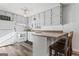 Well-lit kitchen with abundant white cabinets, modern appliances, and a breakfast bar at 152 Summerfield Dr, Mcdonough, GA 30253