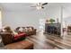 Open-concept living room with a fireplace, hardwood floors, and comfortable seating area at 152 Summerfield Dr, Mcdonough, GA 30253