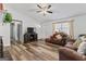 Inviting living room featuring wood-look floors, a ceiling fan, and comfortable brown furniture at 152 Summerfield Dr, Mcdonough, GA 30253