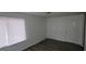 Bright bedroom with wood flooring, white walls, and two closets at 5796 Par Four Ct, Lithonia, GA 30038